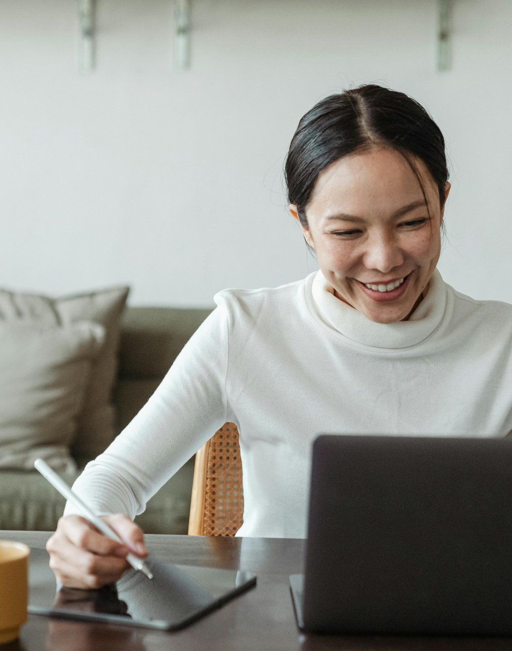 A woman attending a telehealth therapy session from home