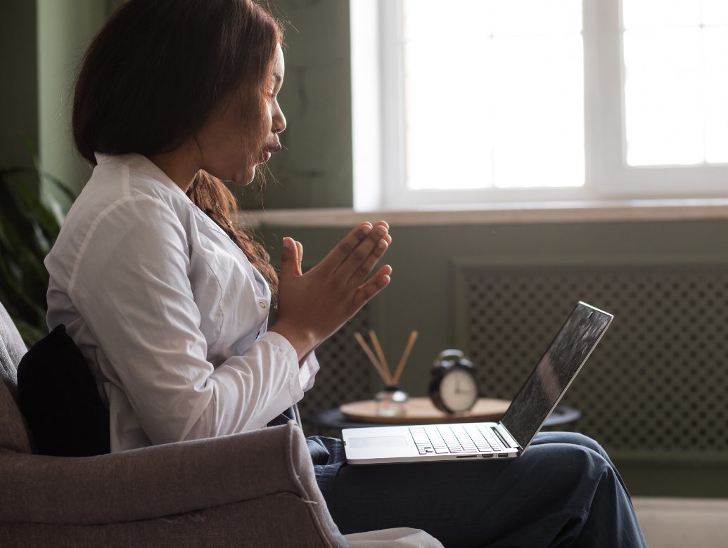 A person feeling calm and supported during an at-home video therapy session